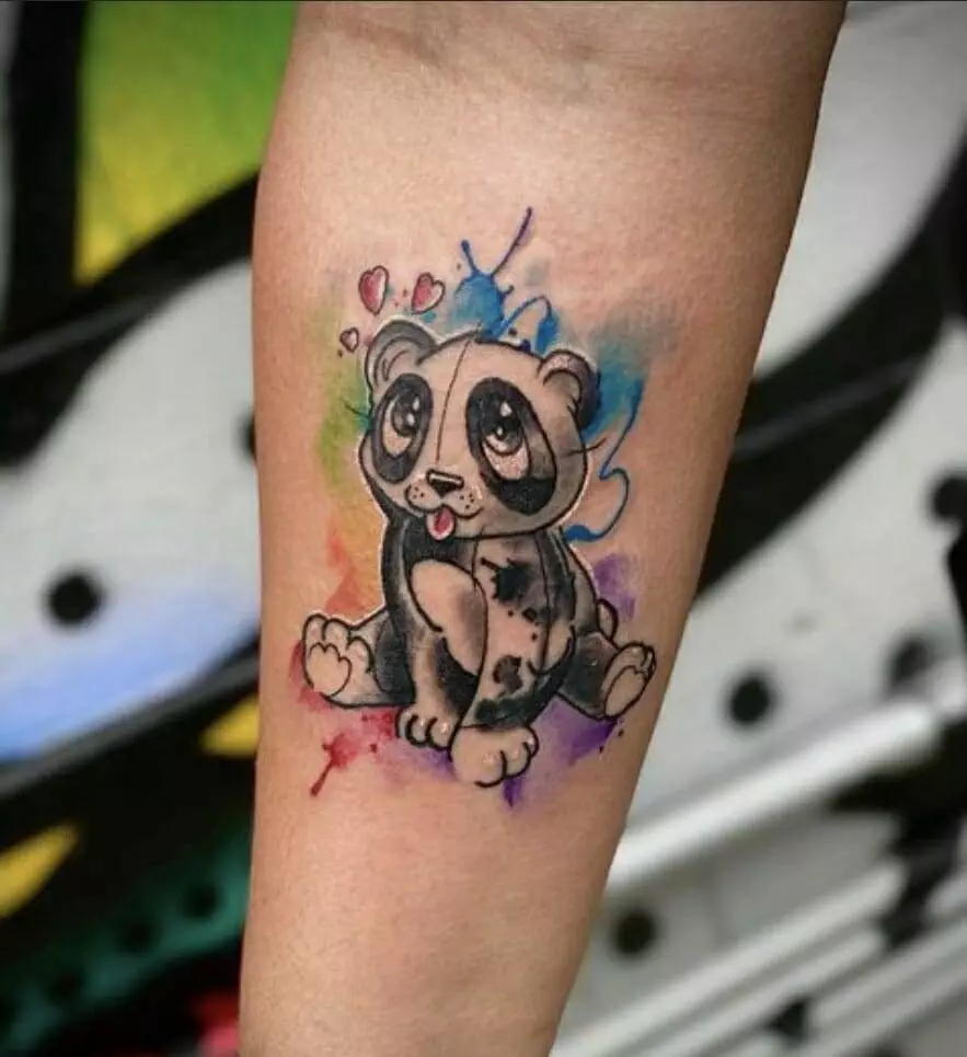 A panda bear tattoo on a woman's forearm.