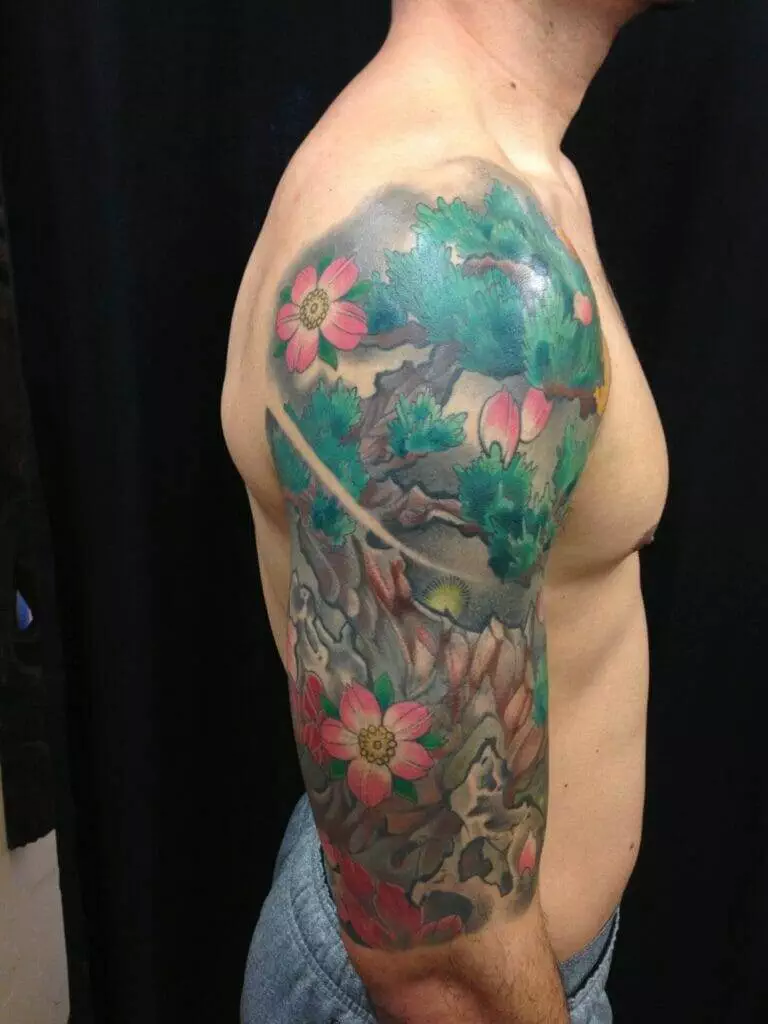 A man adorned with a sleeve tattoo of flowers.