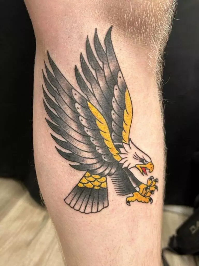 An eagle tattoo on a man's leg.