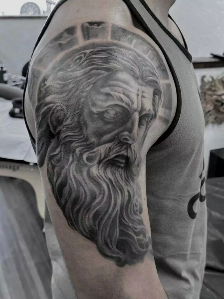 A man with a tattoo of a man with a beard.