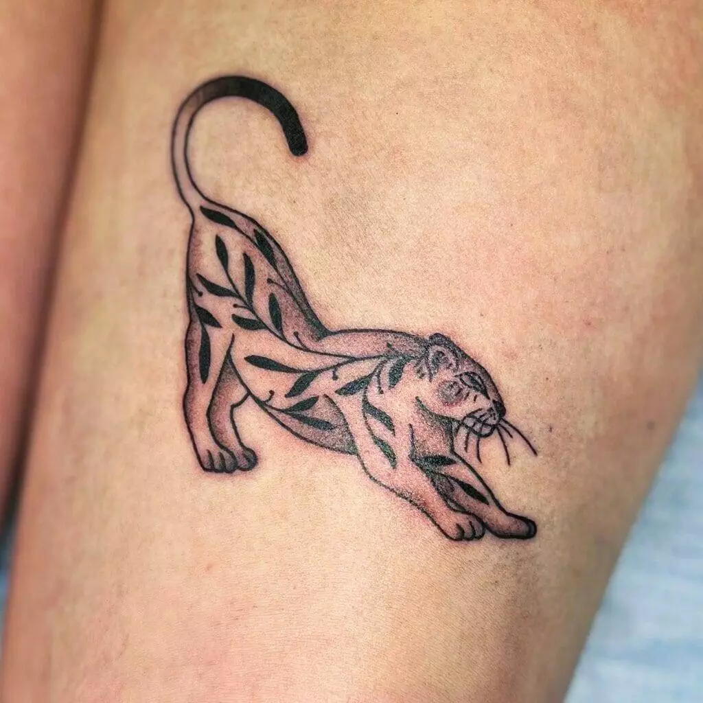 A tattoo of a tiger on a woman's thigh.