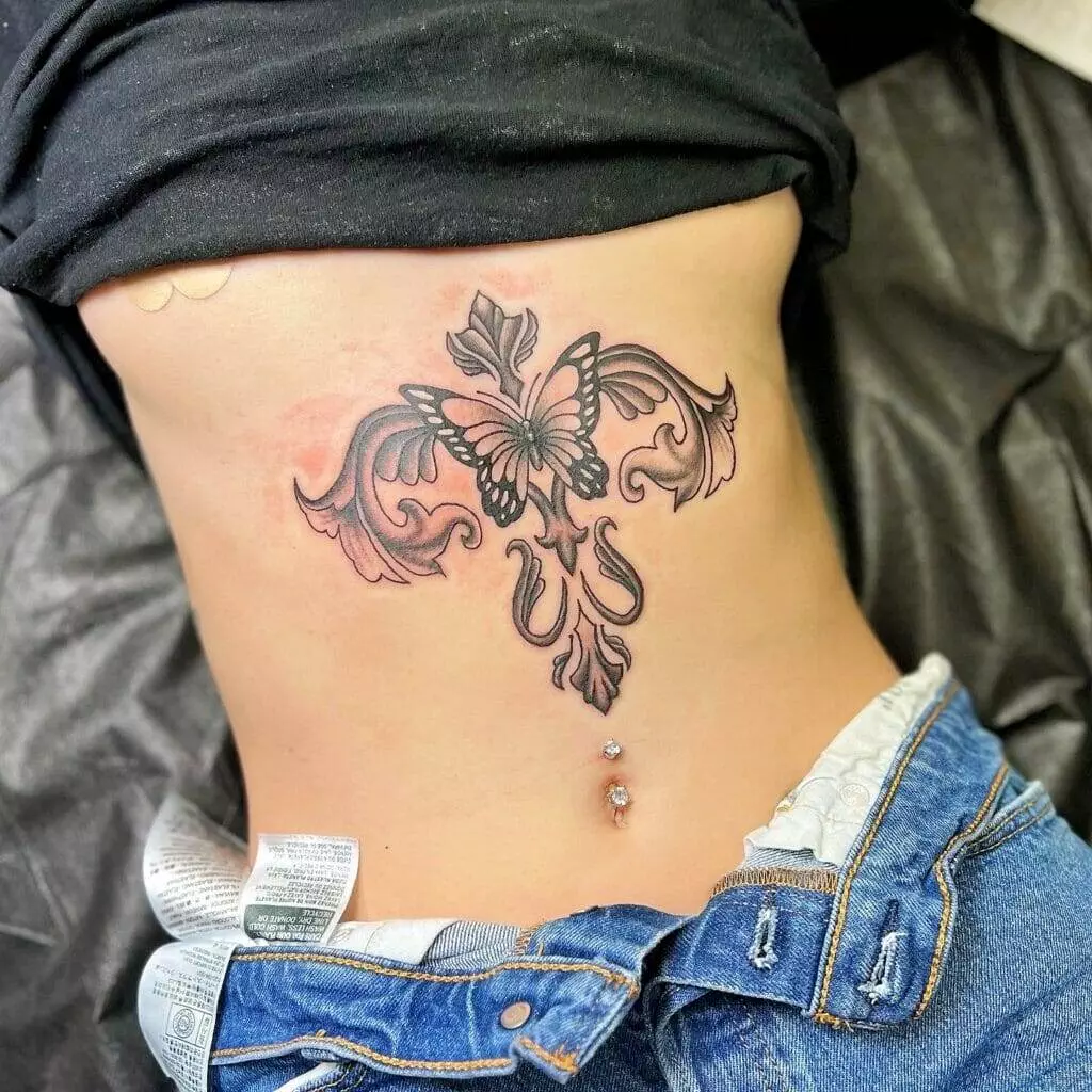 A woman with a butterfly tattoo on her stomach.