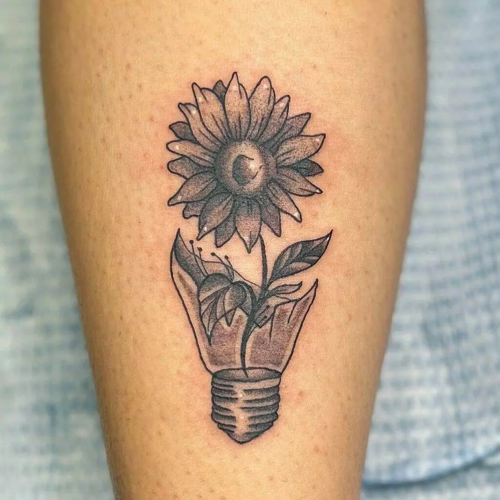 A tattoo of a sunflower in a light bulb.