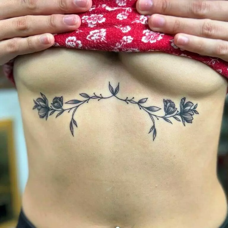 A woman with a tattoo of flowers on her stomach.