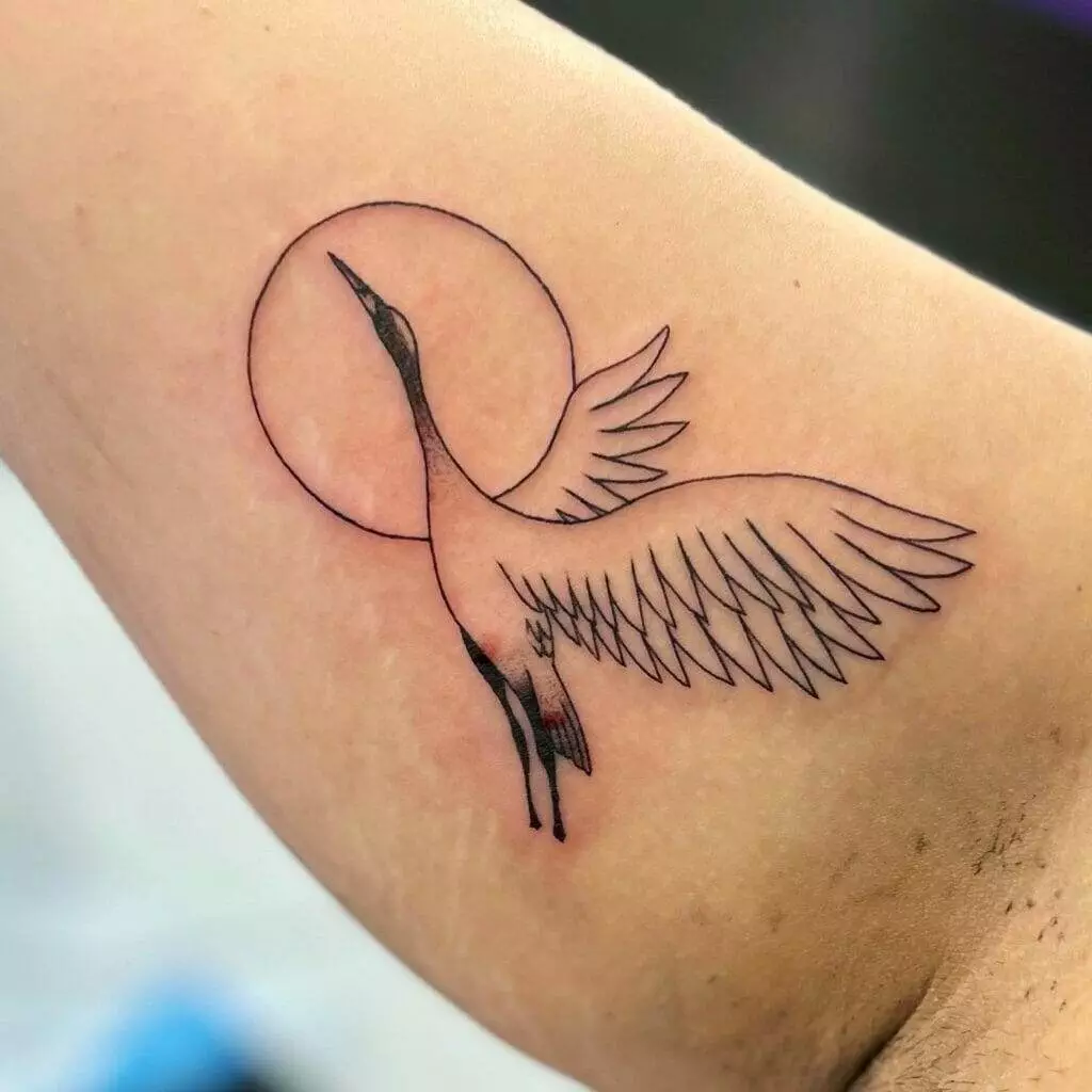 A tattoo of a crane on the arm.