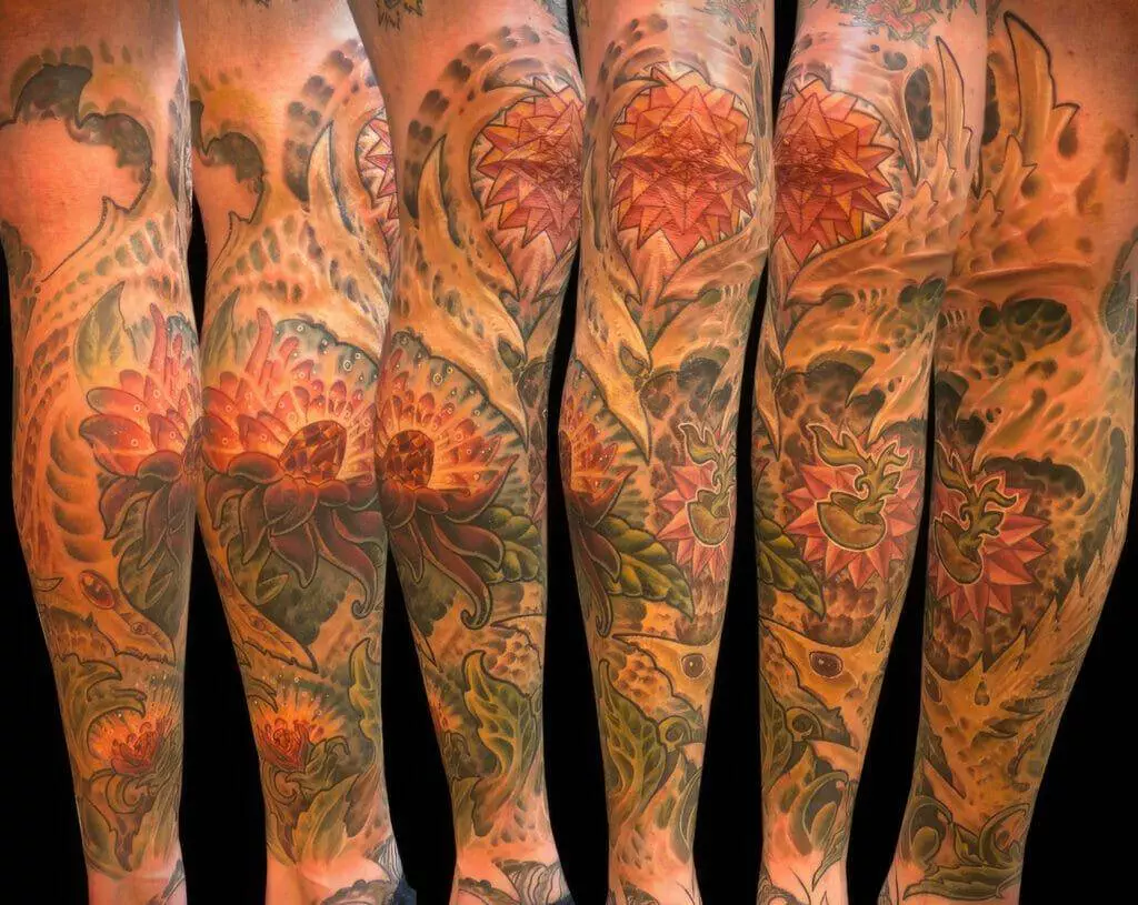 Four sleeve tattoos with flowers on them.