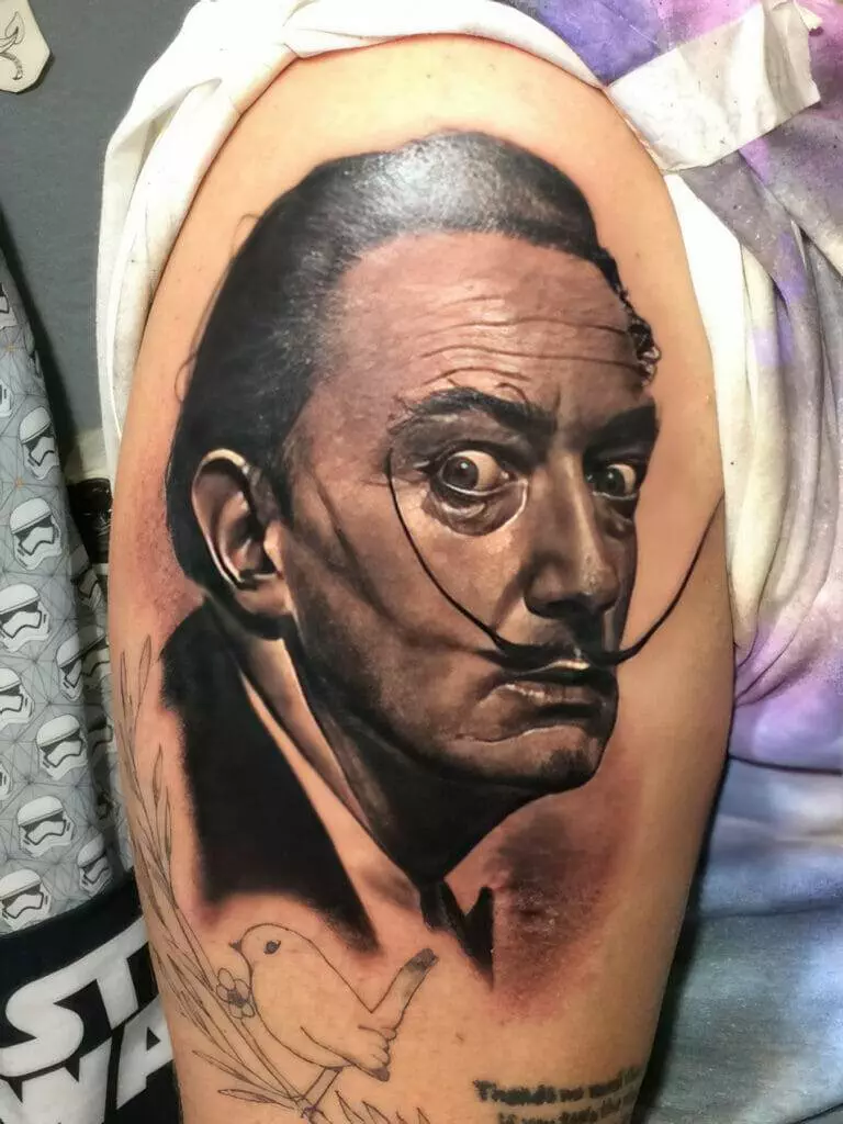 A tattoo of a man with a bird on his arm.