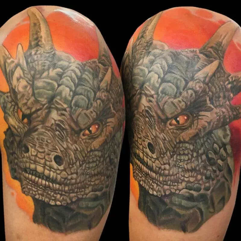 A tattoo of a dragon on a man's sleeve.
