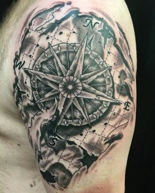 A compass tattoo on a man's shoulder.