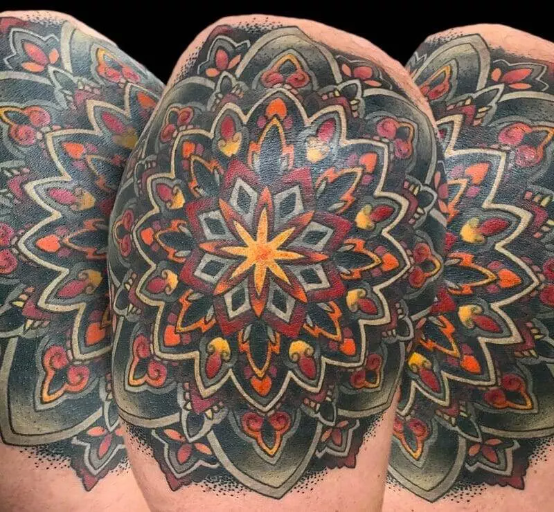 A man with a tattoo of a mandala on his sleeve.