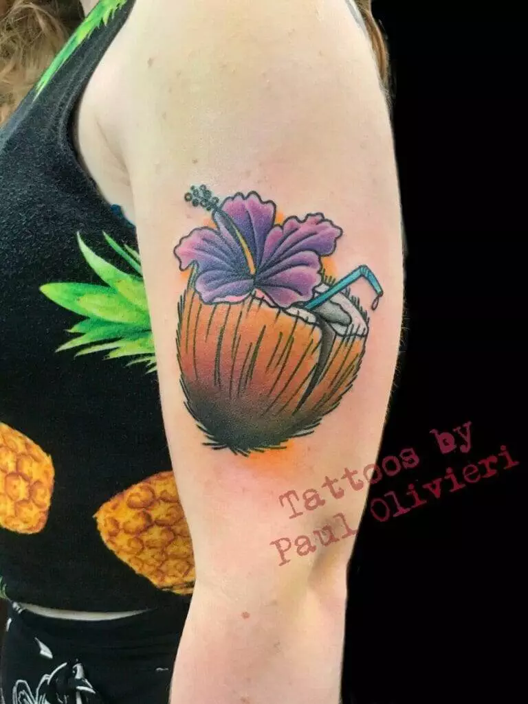 A tattoo of a hawaiian coconut with a pineapple on it.