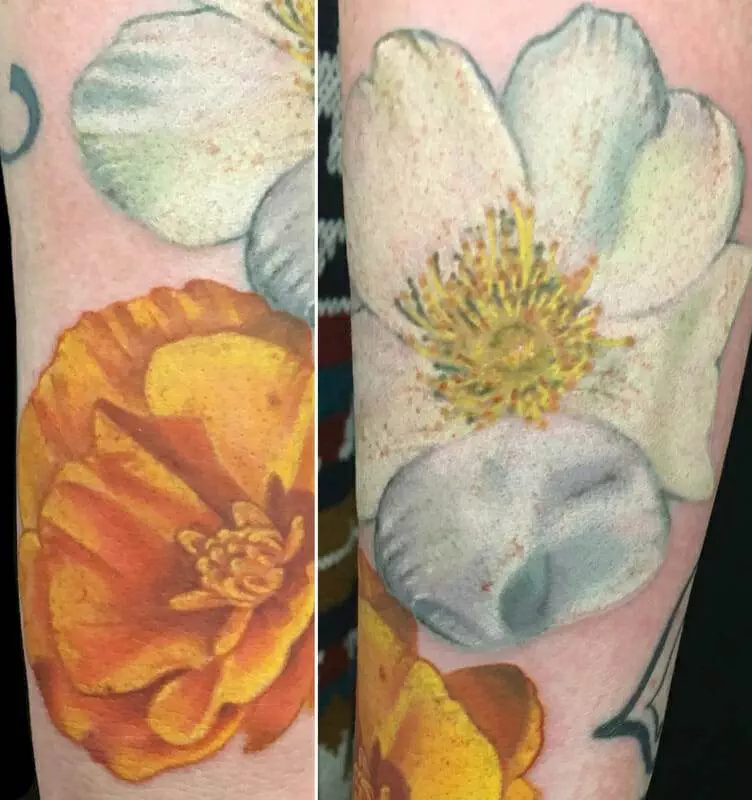 Two different tattoos of flowers on the forearm.