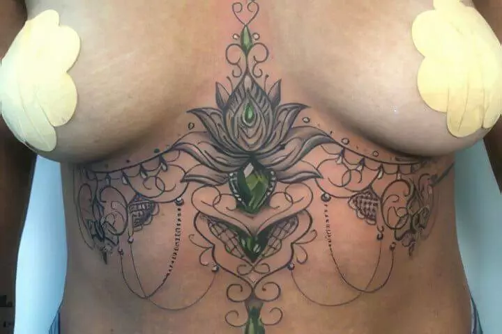 A woman with a tattoo on her chest.