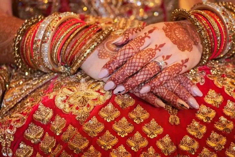 An indian bride's hands are decorated with henna.