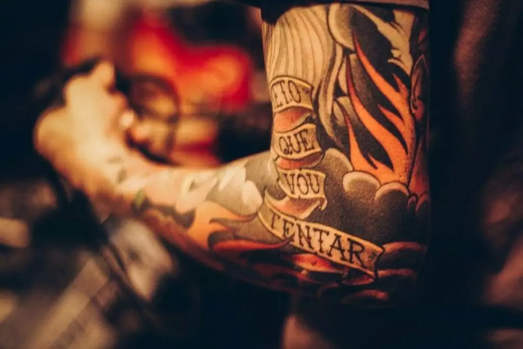 A man with a tattoo on his arm.