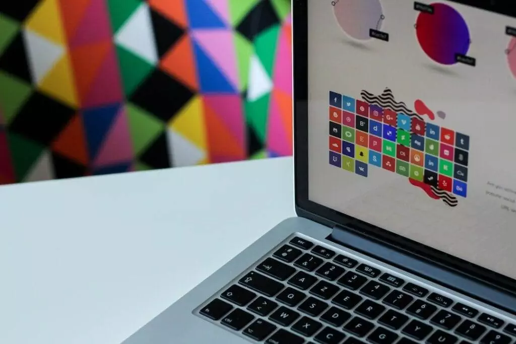 A laptop with a colorful background on it.